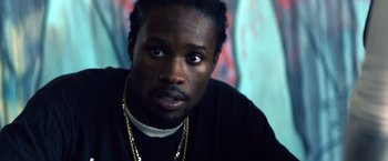 Movie still from “Cut Throat City” (2020), directed by RZA – A person wearing a black shirt; Close Up shot, Over the shoulder angle