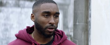 Movie still from “Cut Throat City” (2020), directed by RZA – A person with a beard; Close Up shot, Over the shoulder angle