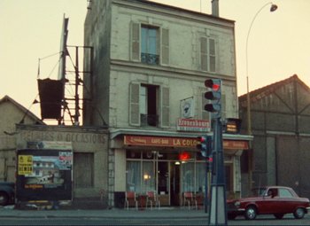 Movie still from “Celine and Julie Go Boating” (1974), directed by Jacques Rivette – An old building on the side of the street; Extreme Wide shot, Low angle
