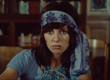 Movie still from “Celine and Julie Go Boating” (1974), directed by Jacques Rivette – A woman with a bandana around her head; Close Up shot, High angle