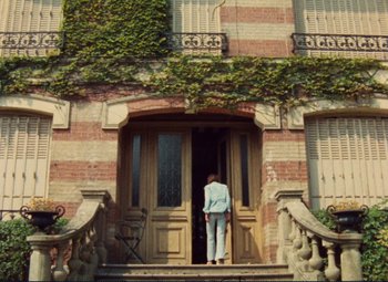 Movie still from “Celine and Julie Go Boating” (1974), directed by Jacques Rivette – A person standing in front of an open front door; Extreme Wide shot, Low angle