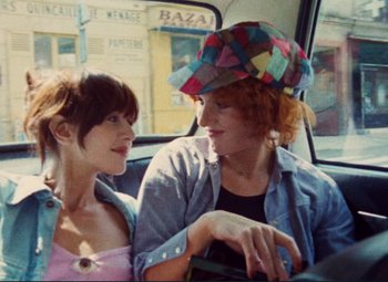 Movie still from “Celine and Julie Go Boating” (1974), directed by Jacques Rivette – Two women sitting in the back seat of a car; Close Up shot, Overhead angle