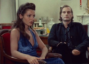 Movie still from “Celine and Julie Go Boating” (1974), directed by Jacques Rivette – A man and a woman sitting next to each other; Medium shot, High angle