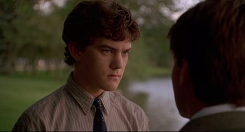 Movie still from “D3: The Mighty Ducks” (1996), directed by Robert Lieberman – A young man in a striped dress shirt and a tie; Close Up shot, Over the shoulder angle