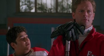 Movie still from “D3: The Mighty Ducks” (1996), directed by Robert Lieberman – A man in a red jacket and a boy in a red jacket; Close Up shot, Low angle