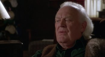 Movie still from “D3: The Mighty Ducks” (1996), directed by Robert Lieberman – An older man sitting in front of a window; Close Up shot, Low angle