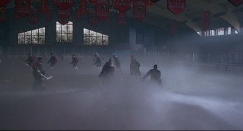 Movie still from “D3: The Mighty Ducks” (1996), directed by Robert Lieberman – A group of men playing a game of ice hockey in the fog; Extreme Wide shot, High angle