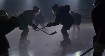 Movie still from “D3: The Mighty Ducks” (1996), directed by Robert Lieberman – A group of men playing a game of ice hockey; Wide shot, Low angle