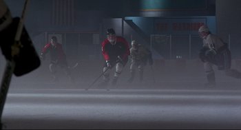 Movie still from “D3: The Mighty Ducks” (1996), directed by Robert Lieberman – A group of men playing a game of ice hockey; Wide shot, Low angle