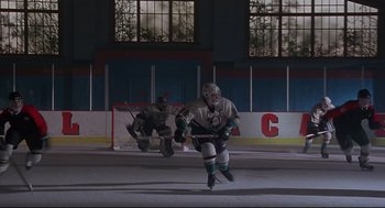Movie still from “D3: The Mighty Ducks” (1996), directed by Robert Lieberman – Two hockey players are playing a game on the ice; Wide shot, Low angle