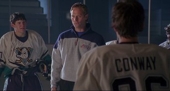 Movie still from “D3: The Mighty Ducks” (1996), directed by Robert Lieberman – A man standing in front of two other men; Medium shot, Over the shoulder angle