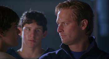 Movie still from “D3: The Mighty Ducks” (1996), directed by Robert Lieberman – A man and a young boy looking at the camera; Close Up shot, Low angle