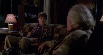 Movie still from “D3: The Mighty Ducks” (1996), directed by Robert Lieberman – A young man sitting on a couch talking to an older man; Medium shot, Over the shoulder angle