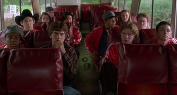 Movie still from “D3: The Mighty Ducks” (1996), directed by Robert Lieberman – A group of young people riding on a bus; Medium shot, High angle