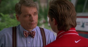 Movie still from “D3: The Mighty Ducks” (1996), directed by Robert Lieberman – A man wearing a bow tie talking to another man; Close Up shot, Over the shoulder angle