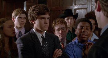 Movie still from “D3: The Mighty Ducks” (1996), directed by Robert Lieberman – A group of young men standing next to each other in a room; Close Up shot, Over the shoulder angle