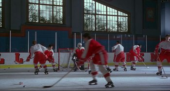 Movie still from “D3: The Mighty Ducks” (1996), directed by Robert Lieberman – A group of men playing a game of ice hockey; Extreme Wide shot, High angle