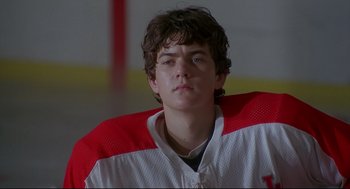 Movie still from “D3: The Mighty Ducks” (1996), directed by Robert Lieberman – A person wearing a hockey uniform; Close Up shot, Low angle
