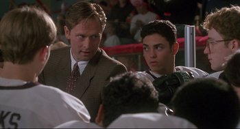 Two men in a boxing ring talking to each other