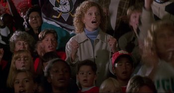 Movie still from “D3: The Mighty Ducks” (1996), directed by Robert Lieberman – A group of people in a room singing; Medium shot, High angle