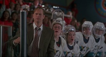 Movie still from “D3: The Mighty Ducks” (1996), directed by Robert Lieberman – A group of people in a hockey arena; Medium shot, Low angle