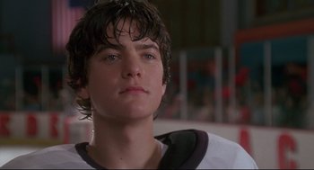 Movie still from “D3: The Mighty Ducks” (1996), directed by Robert Lieberman – A person with a hockey uniform on; Close Up shot, Low angle