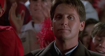 Movie still from “D3: The Mighty Ducks” (1996), directed by Robert Lieberman – A person wearing a suit and tie; Close Up shot, Low angle