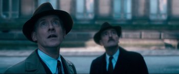 Movie still from “Dad's Army” (2016), directed by Oliver Parker – Two men in suits and hats looking up at something; Close Up shot, Low angle