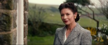 Movie still from “Dad's Army” (2016), directed by Oliver Parker – A woman in a gray jacket and a white shirt; Close Up shot, Over the shoulder angle