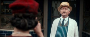 Movie still from “Dad's Army” (2016), directed by Oliver Parker – An older man wearing a hat and a tie; Medium shot, Over the shoulder angle