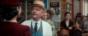 Movie still from “Dad's Army” (2016), directed by Oliver Parker – An older man wearing a hat and a tie; Close Up shot, Over the shoulder angle