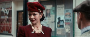 Movie still from “Dad's Army” (2016), directed by Oliver Parker – A woman wearing a red hat and a red jacket; Close Up shot, Over the shoulder angle