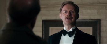 Movie still from “Dad's Army” (2016), directed by Oliver Parker – A man in a tuxedo looking at himself in the mirror; Close Up shot, Over the shoulder angle