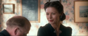 Movie still from “Dad's Army” (2016), directed by Oliver Parker – A person wearing a suit; Close Up shot, Over the shoulder angle