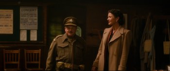 Movie still from “Dad's Army” (2016), directed by Oliver Parker – A man and a woman are standing next to each other; Medium shot, Over the shoulder angle