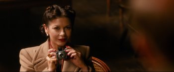 Movie still from “Dad's Army” (2016), directed by Oliver Parker – A woman holding up a camera in a chair; Close Up shot, High angle