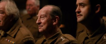Movie still from “Dad's Army” (2016), directed by Oliver Parker – An older man in a military uniform looking to his left; Close Up shot, Over the shoulder angle