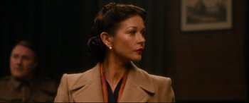 Movie still from “Dad's Army” (2016), directed by Oliver Parker – An older woman with brown hair wearing a brown coat; Close Up shot, Over the shoulder angle