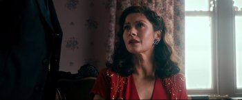 Movie still from “Dad's Army” (2016), directed by Oliver Parker – A woman in a red dress is looking off to the side; Close Up shot, Low angle