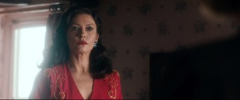 Movie still from “Dad's Army” (2016), directed by Oliver Parker – A woman in a red dress is standing in front of a mirror; Close Up shot, Low angle