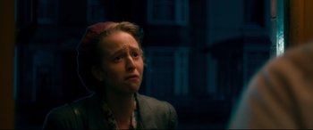 Movie still from “Dad's Army” (2016), directed by Oliver Parker – A woman in a gray jacket is looking up; Close Up shot, Over the shoulder angle