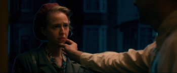 Movie still from “Dad's Army” (2016), directed by Oliver Parker – A woman on a cell phone with another person touching her ear; Close Up shot, Over the shoulder angle