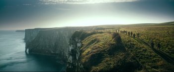 Movie still from “Dad's Army” (2016), directed by Oliver Parker – A group of people standing on top of a cliff; Extreme Wide shot, High angle