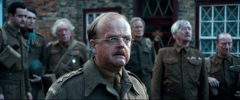 Movie still from “Dad's Army” (2016), directed by Oliver Parker – A man in a military uniform with glasses and a mustache; Close Up shot, Over the shoulder angle