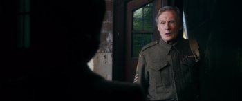 Movie still from “Dad's Army” (2016), directed by Oliver Parker – An older man in a uniform talking to a younger man; Medium shot, Over the shoulder angle