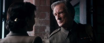 Movie still from “Dad's Army” (2016), directed by Oliver Parker – An older man in a uniform talking to a younger man; Close Up shot, Over the shoulder angle