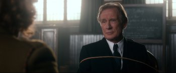 Movie still from “Dad's Army” (2016), directed by Oliver Parker – A man in a suit and tie with a rope around his neck; Close Up shot, Over the shoulder angle