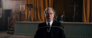 Movie still from “Dad's Army” (2016), directed by Oliver Parker – An older man in a suit and tie; Medium shot, Low angle