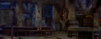 Movie still from “Daddy Long Legs” (1955), directed by Jean Negulesco – A woman standing on top of a wooden bench; Wide shot, Low angle