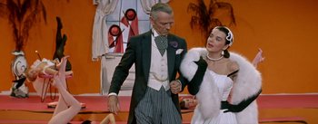 Movie still from “Daddy Long Legs” (1955), directed by Jean Negulesco – A man and a woman dressed in formal wear; Medium shot, Over the shoulder angle